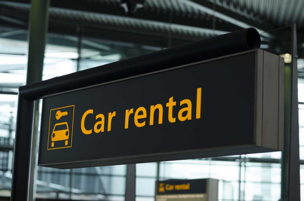 Signage With Direction To Car Rental